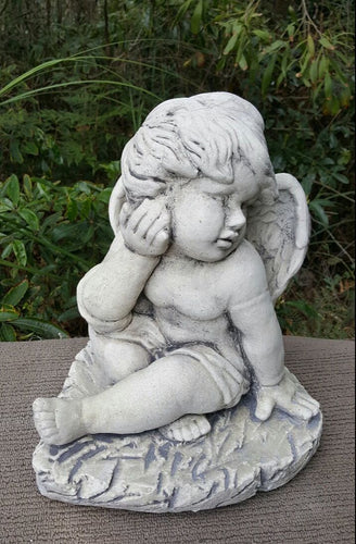 Cherub Holding Face